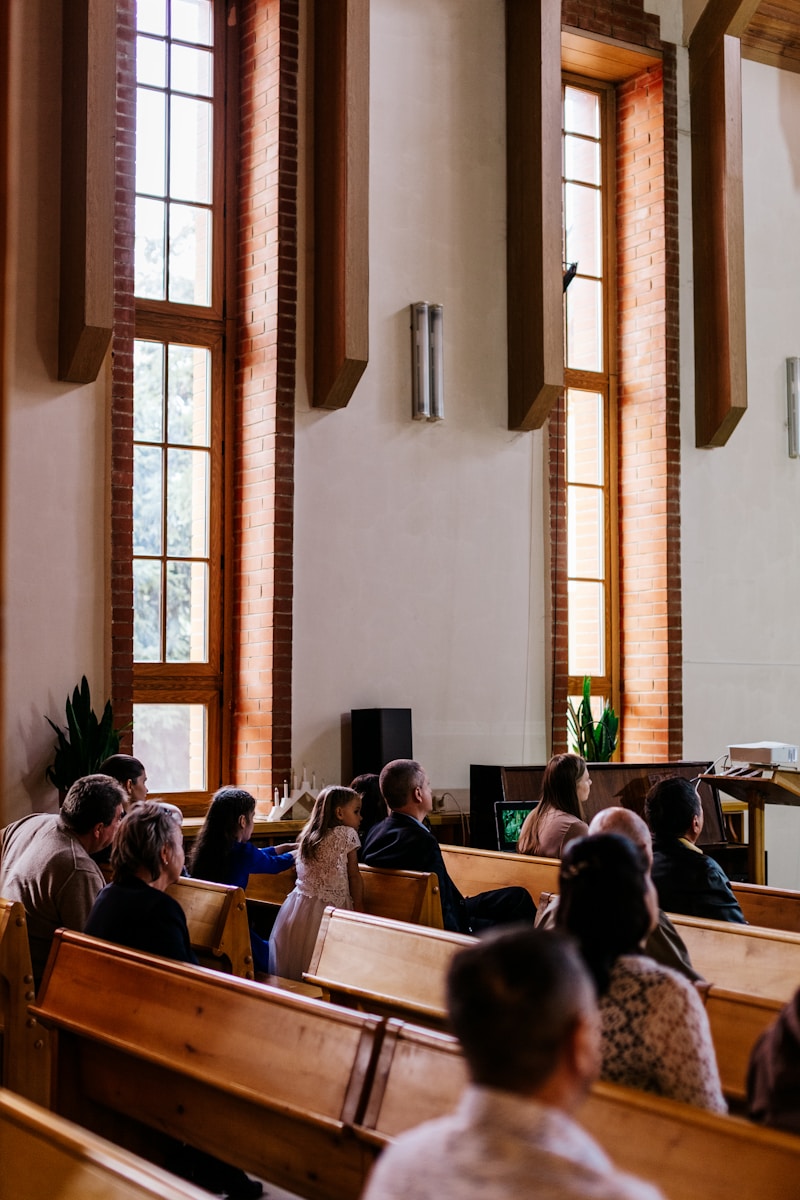a group of people sitting in pews in a church