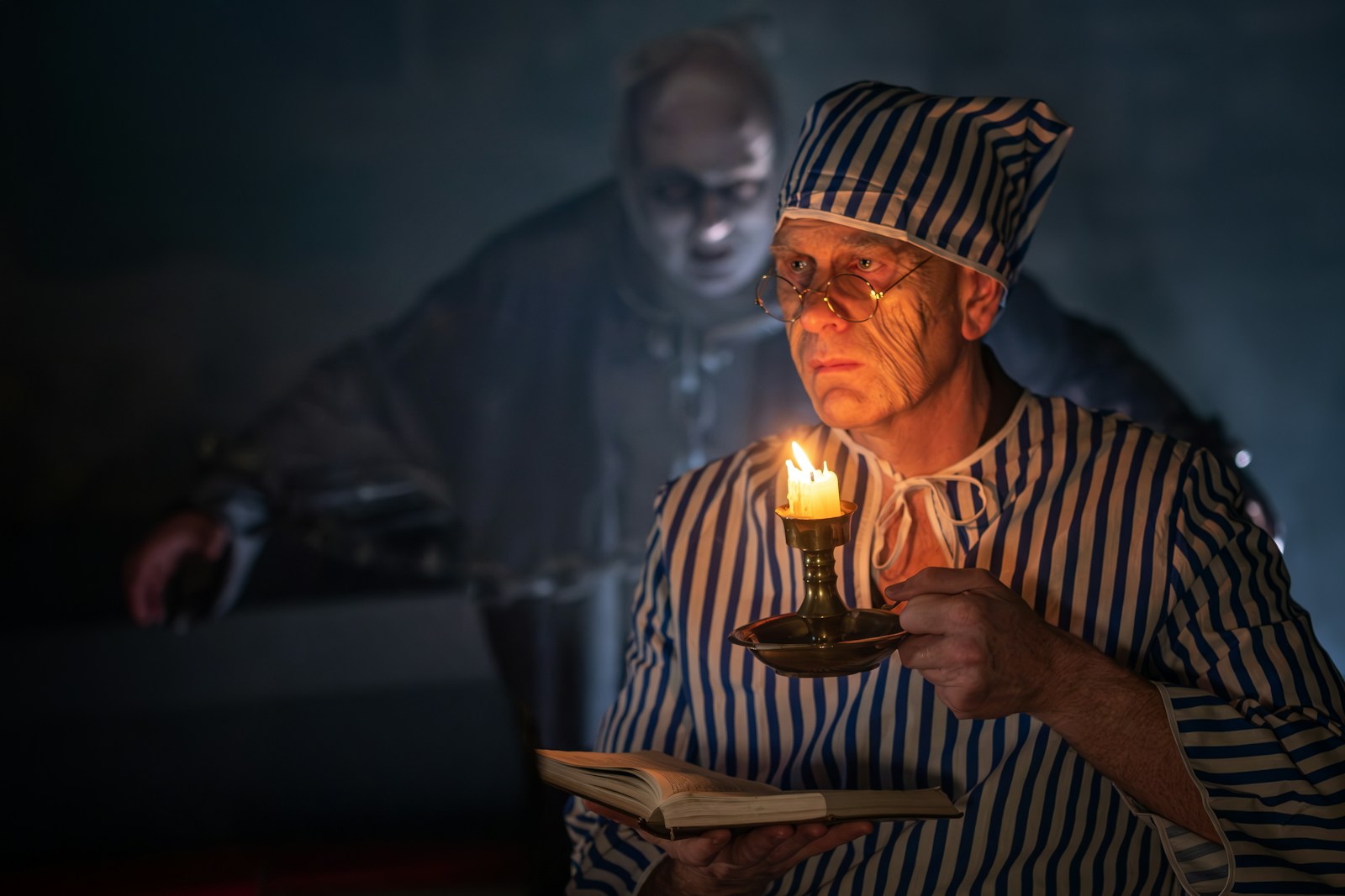 A man holding a lit candle in his hand